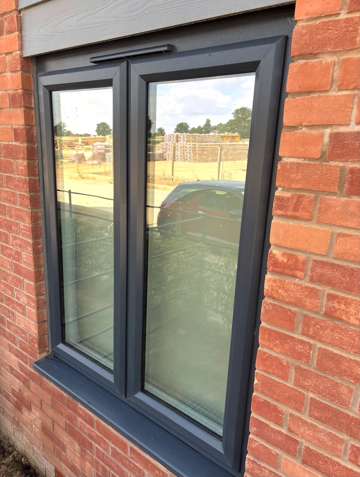 Anthracite grey casement window cleaned on a new build home in Northampton