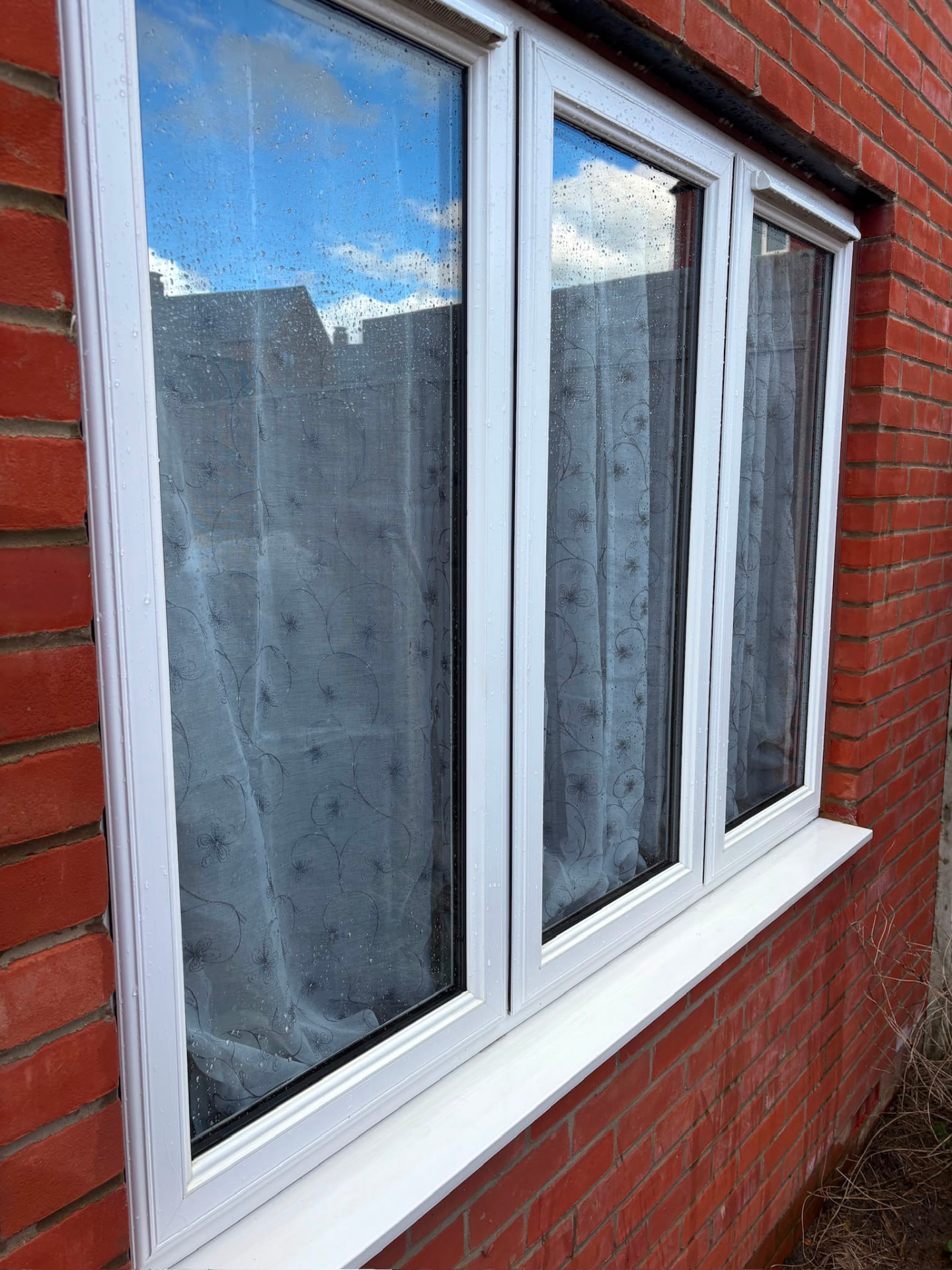 Freshly cleaned white uPVC triple window on a Northampton home