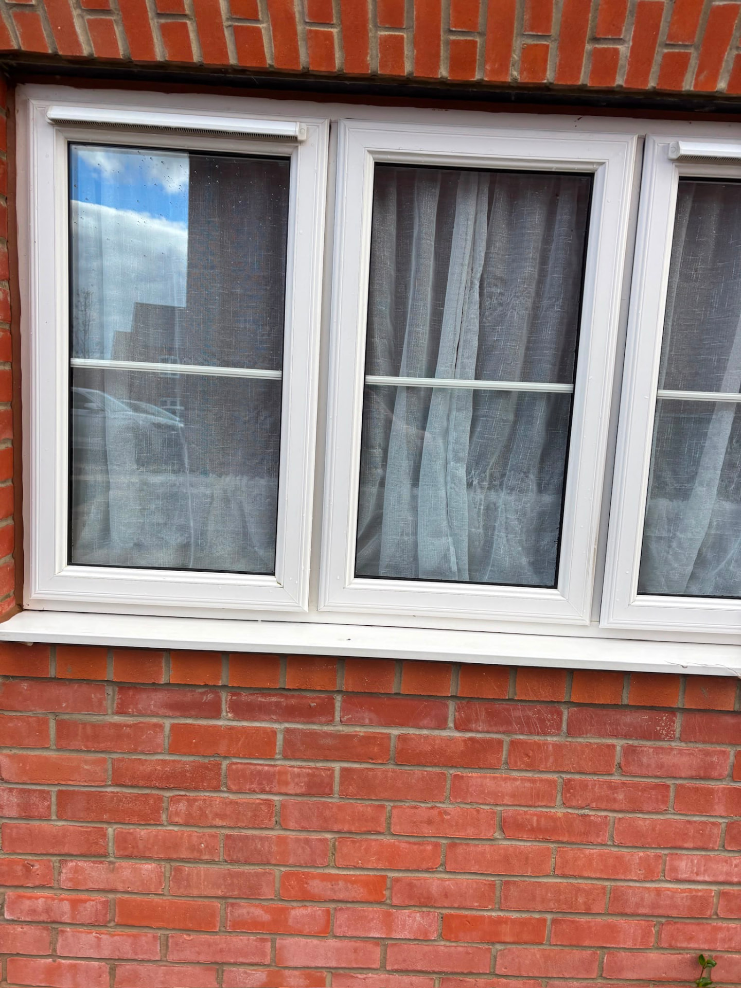 Triple white uPVC window cleaned on a red brick house in Northampton