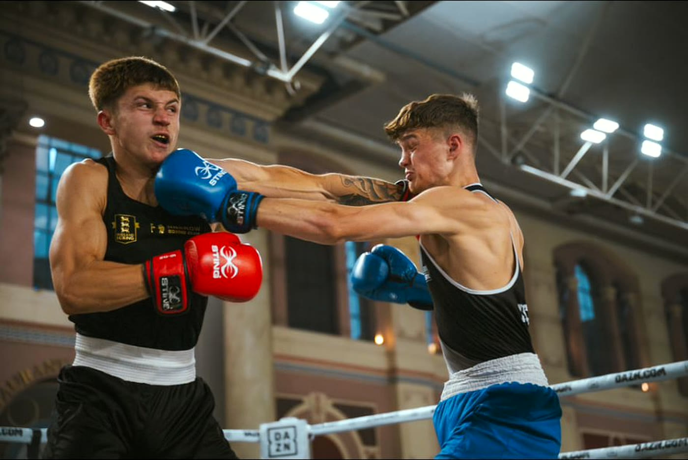 Issac boxing in the ring, landing a jab during an amateur bout