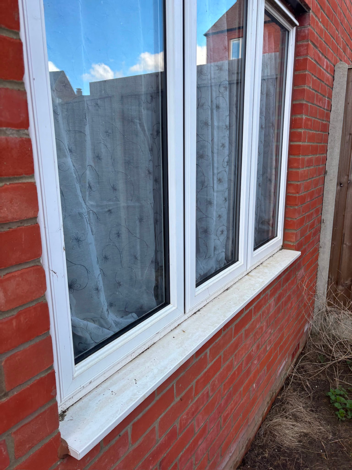 White window with clean frames and a brightened sill in Northampton